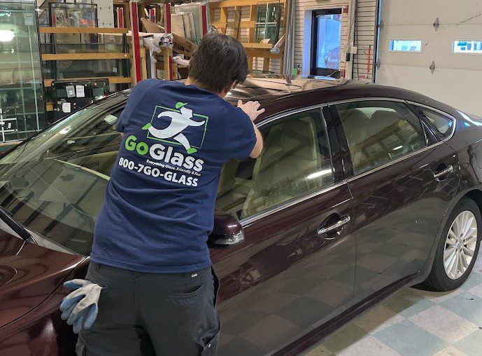 Goglass employee replacing glass windshield