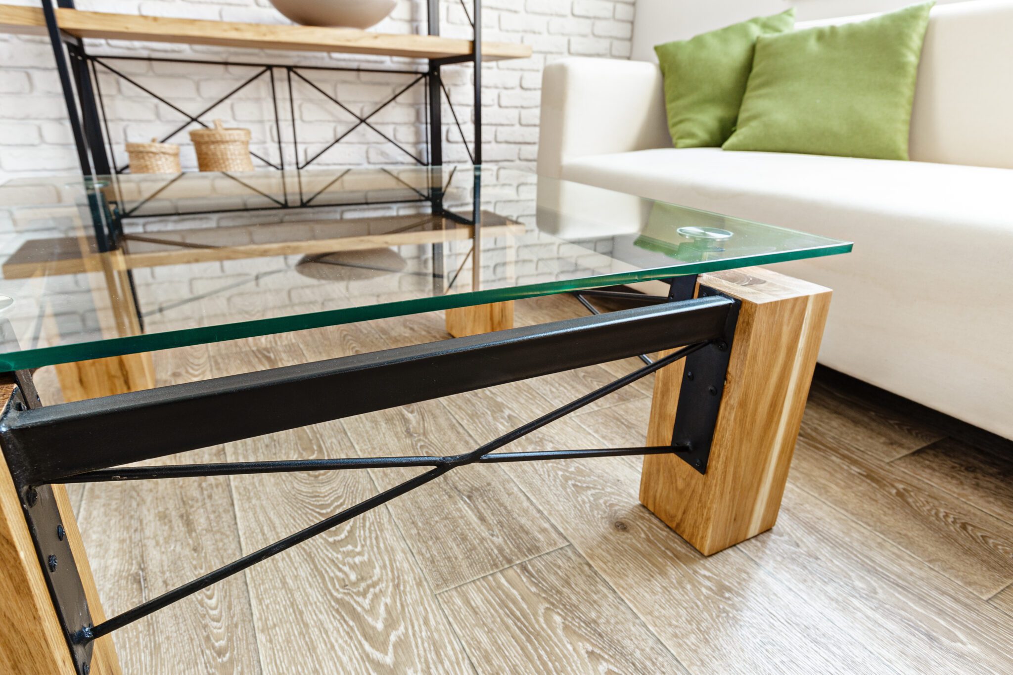 Coffee table with large wood legs black supports and glass top