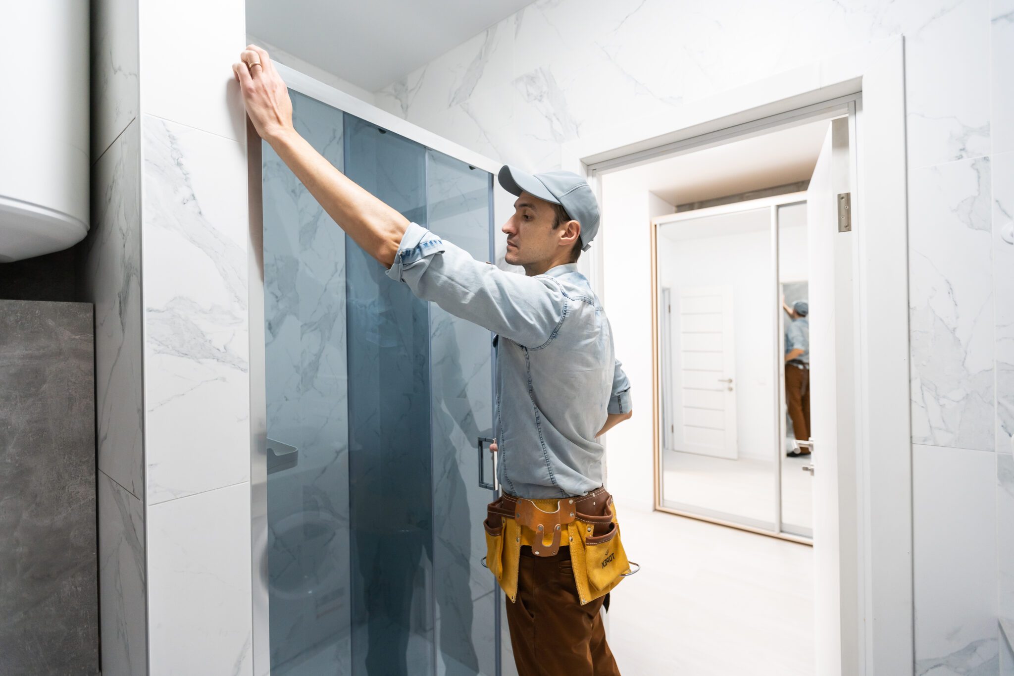 Contractor installing new shower door