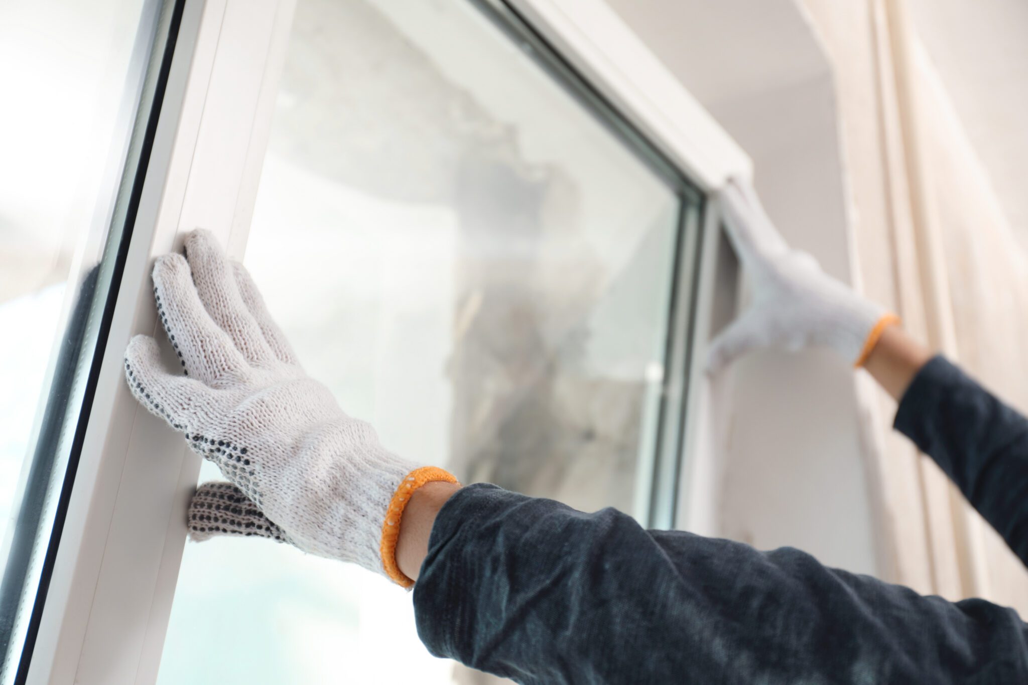 Closeup of contractor installing glass window