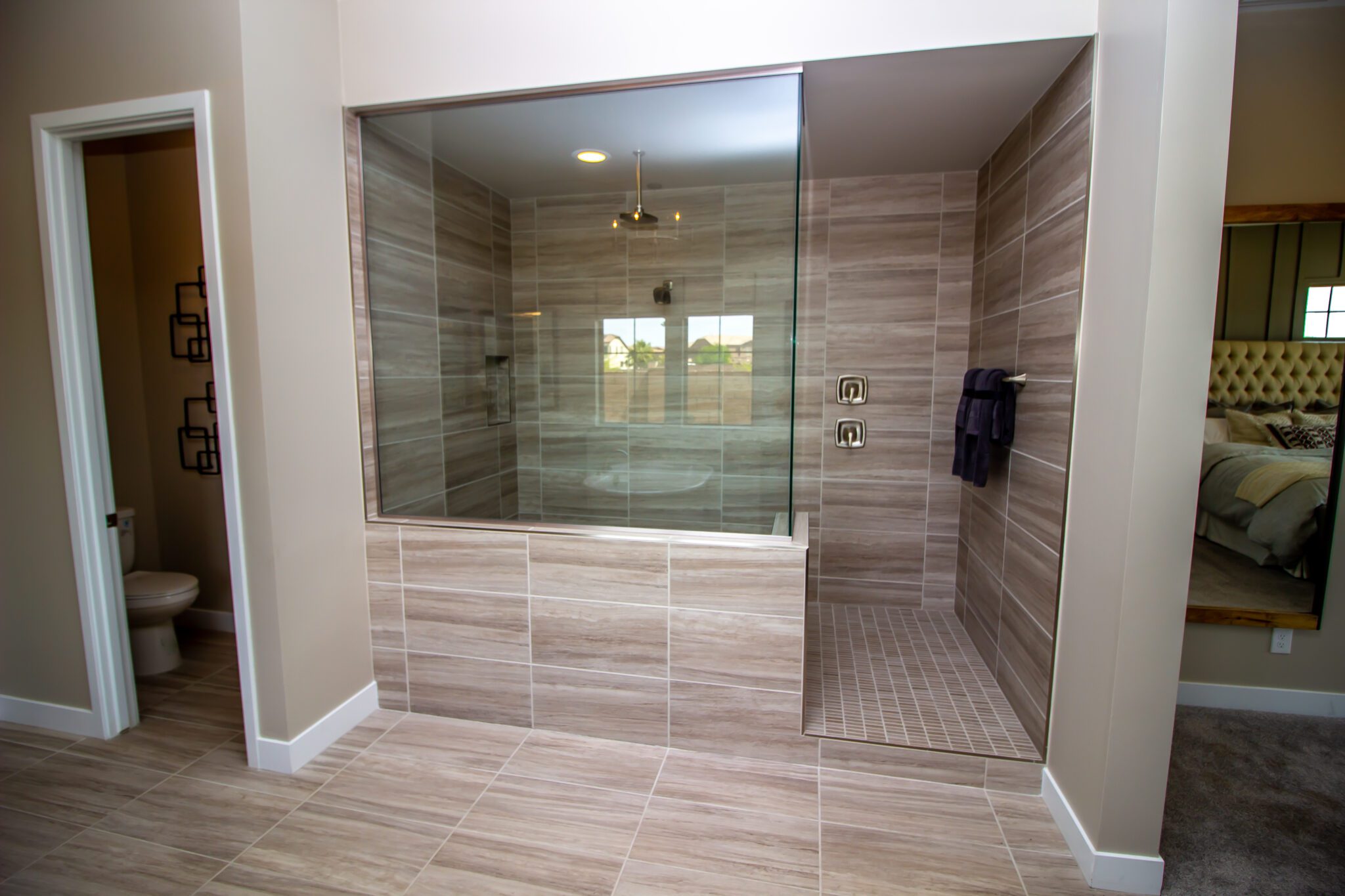 Beige tile large walk-in shower with glass