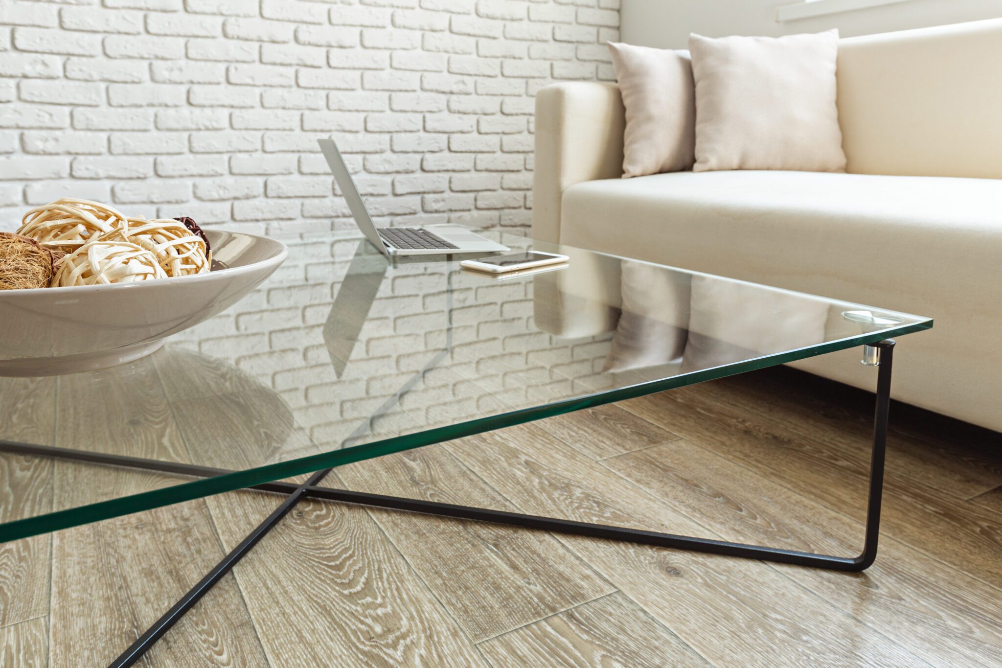 Modern glass coffee table with laptop