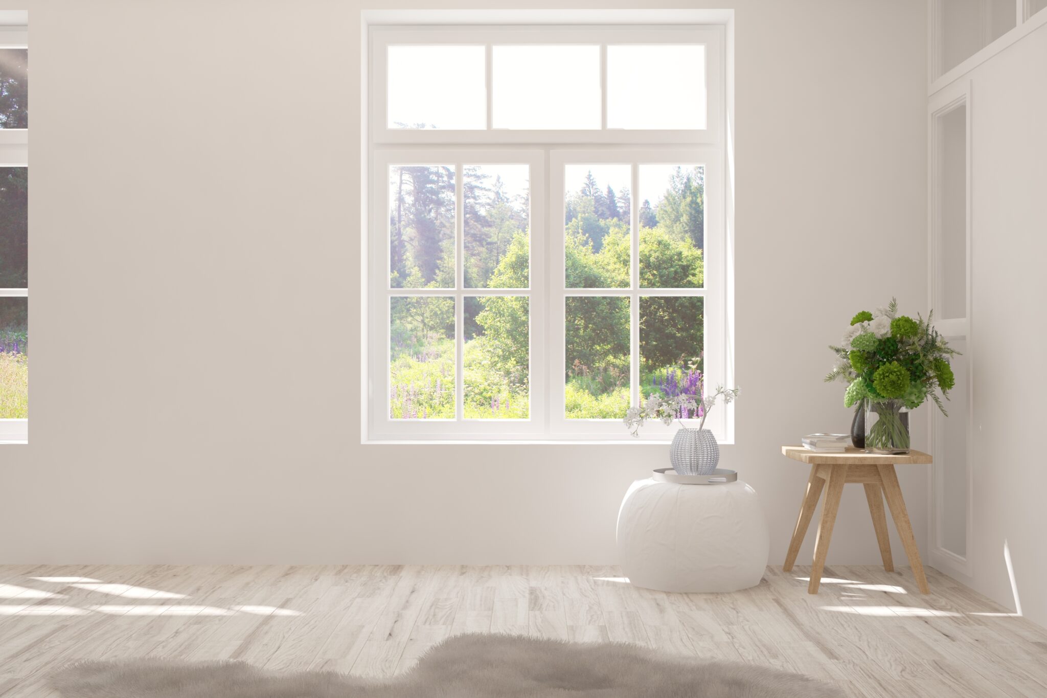 New window with trees outside in white room with laminate floors