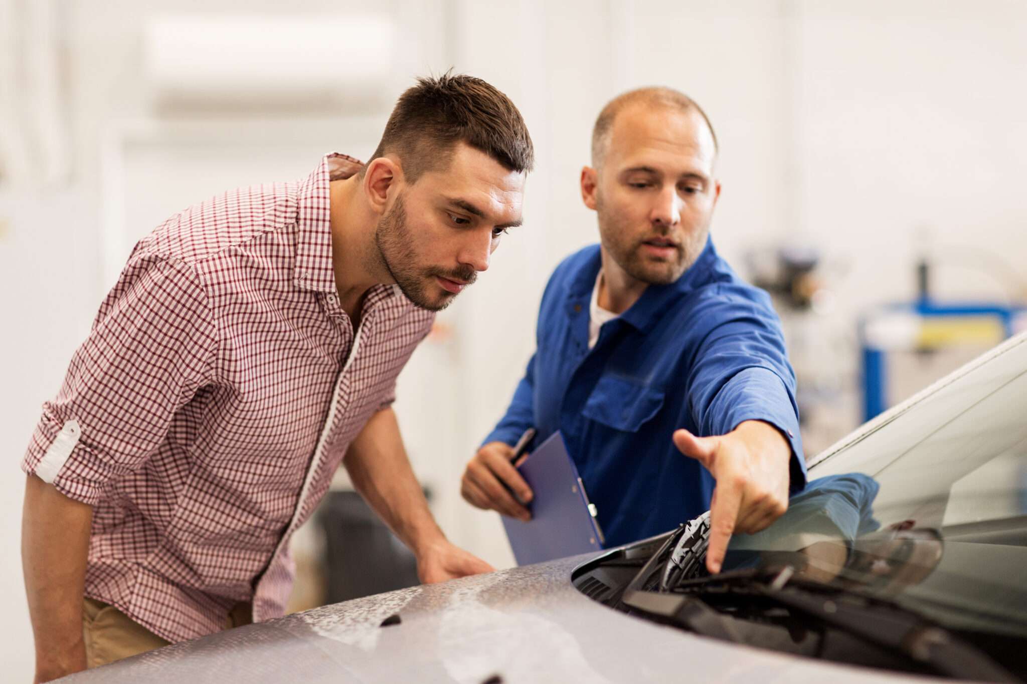 Mechanic pointing at windshield