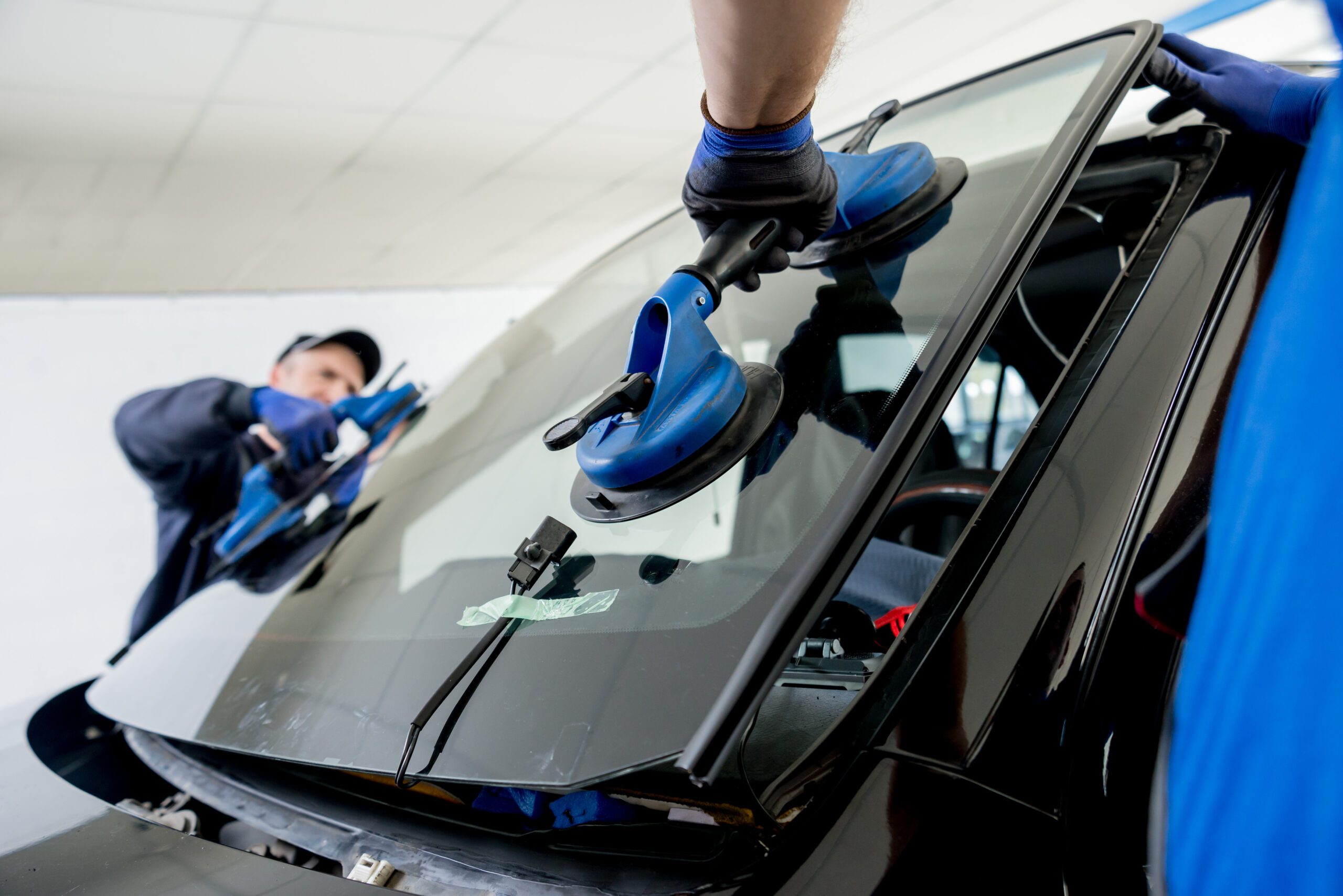 Closeup of windshield installation in shop